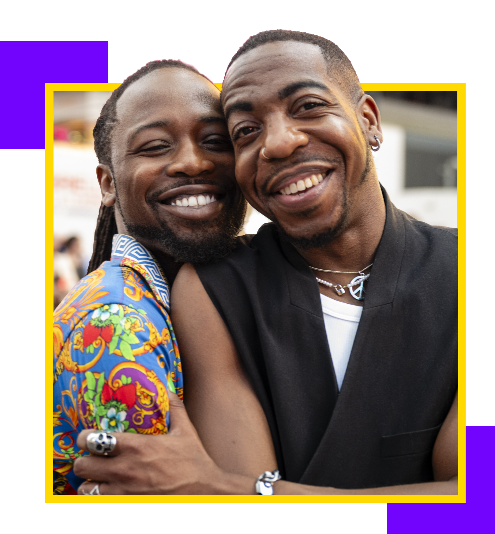 Two men smiling and embracing
